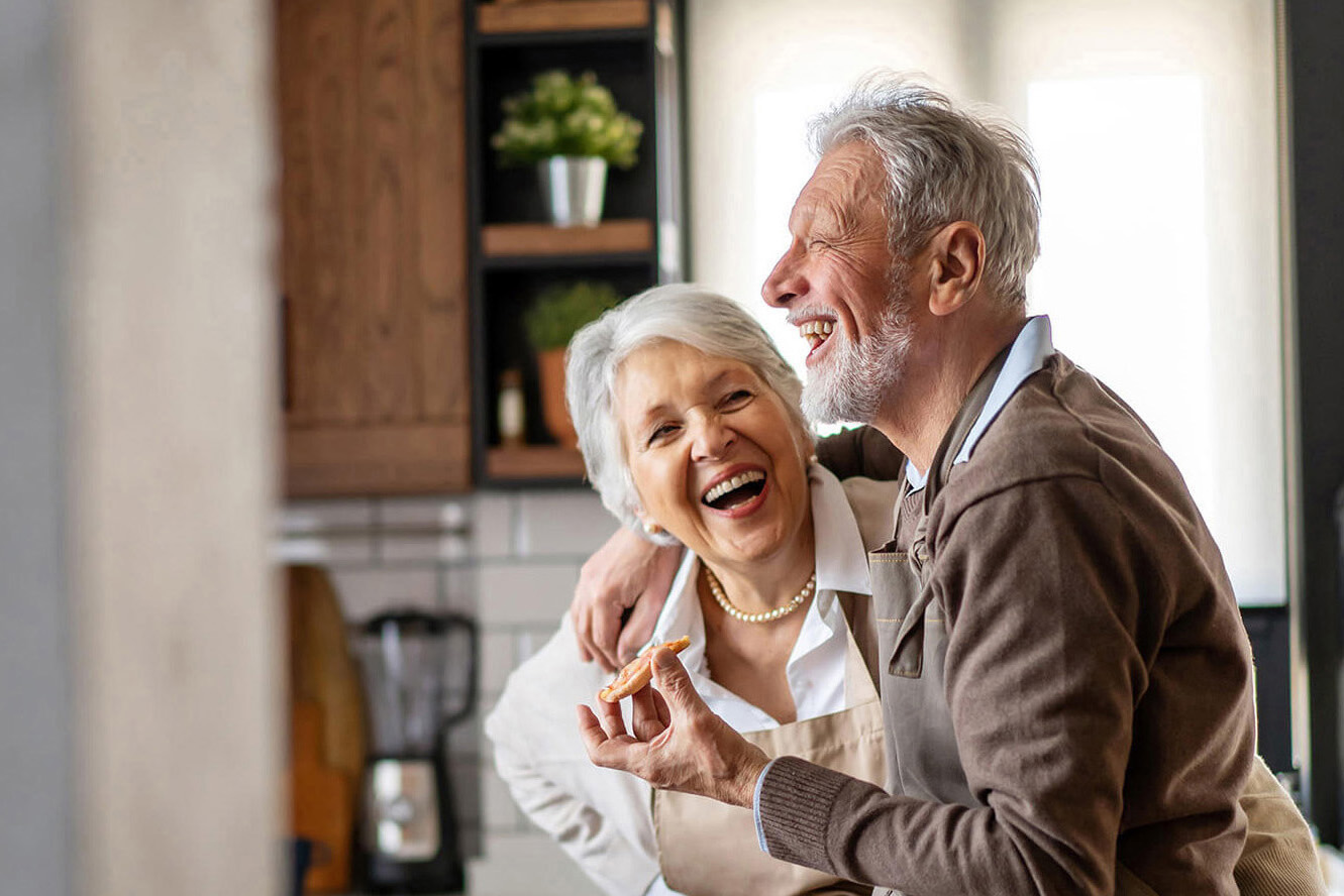 Happy senior couple having fun in the kitchen together
